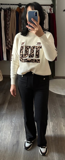 Zwarte jeans met gouden knoop vooraan op de zakken